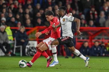 Brennan Johnson #20 of Nottingham Forest breaks with the ball as Aaron Wan-Bissaka #29 of Manchester United gives chase during the Carabao Cup Semi-Finals match Nottingham Forest vs Manchester United at City Ground, Nottingham, United Kingdom, 25th J