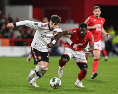Alejandro Garnacho #49 of Manchester United and Serge Aurier #24 of Nottingham Forest battle for the ball during the Carabao Cup Semi-Finals match Nottingham Forest vs Manchester United at City Ground, Nottingham, United Kingdom, 25th January 202