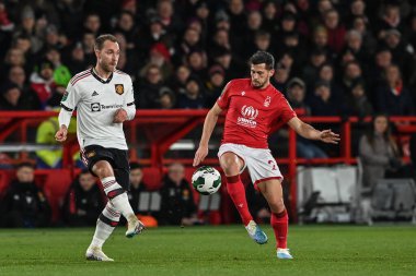 Christian Eriksen #14 of Manchester United passes the ball as Remo Freuler #23 of Nottingham Forest pressures during the Carabao Cup Semi-Finals match Nottingham Forest vs Manchester United at City Ground, Nottingham, United Kingdom, 25th January 202