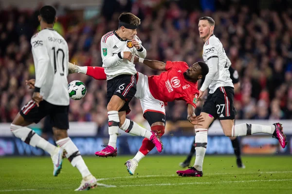 Serge Aurier #24 of Nottingham Forest and Lisandro Martnez #6 of Manchester United battle for the ball during the Carabao Cup Semi-Finals match Nottingham Forest vs Manchester United at City Ground, Nottingham, United Kingdom, 25th January 2023
