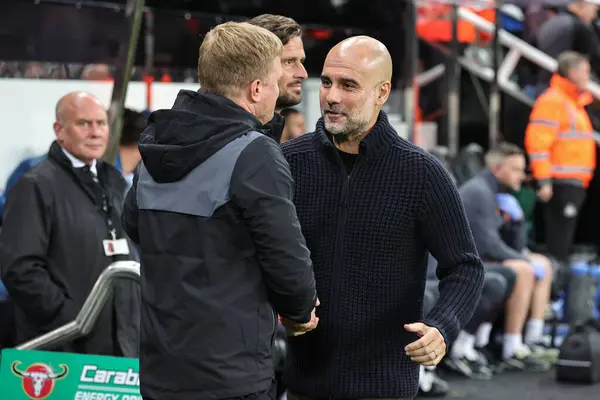 stock image Pep Guardiola manager of Manchester City and Eddie Howe manager of Newcastle United shake hands before the game during the Carabao Cup Third Round match Newcastle United vs Manchester City at St. James's Park, Newcastle, United Kingdom, 27th Septembe