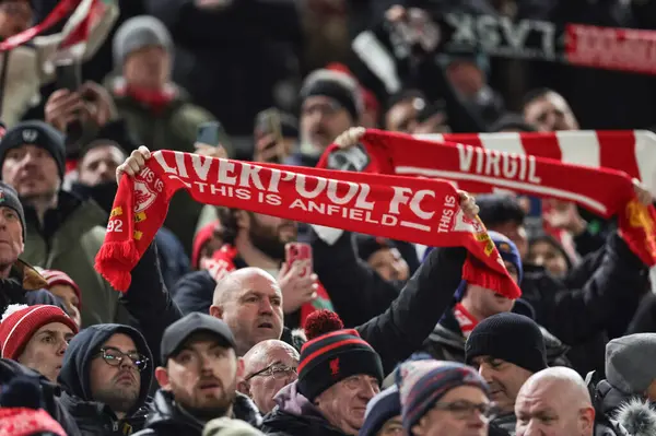 stock image Liverpool fans hold scarfs up as they sing Youll never walk again during the UEFA Europa League match Liverpool vs LASK at Anfield, Liverpool, United Kingdom, 30th November 2023