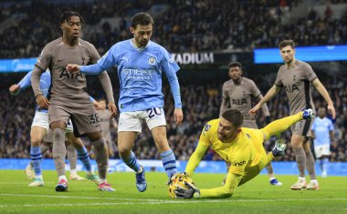 Guglielmo Vicario #13 of Tottenham Hotspur makes a save at the feet of Bernardo Silva #20 of Manchester City during the Premier League match Manchester City vs Tottenham Hotspur at Etihad Stadium, Manchester, United Kingdom, 3rd December 2023 clipart