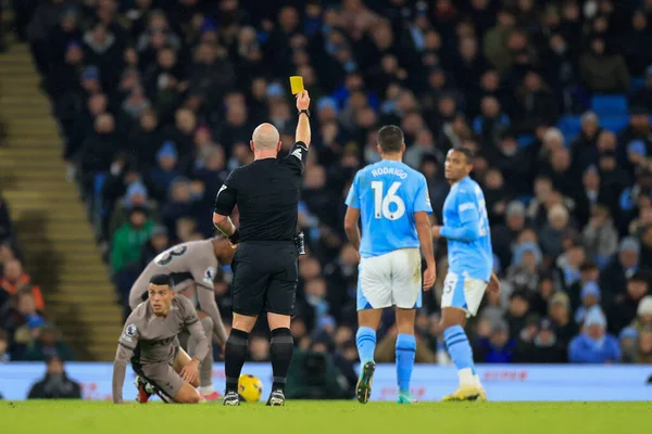 stock image Referee Simon Hooper shows Rodri #16 of Manchester City a yellow card during the Premier League match Manchester City vs Tottenham Hotspur at Etihad Stadium, Manchester, United Kingdom, 3rd December 2023