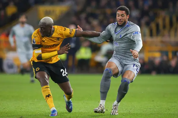 stock image Toti Gomes #24 of Wolverhampton Wanderers and Arnaut Danjuma #10 of Everton battle for the ball during the Premier League match Wolverhampton Wanderers vs Everton at Molineux, Wolverhampton, United Kingdom, 30th December 202