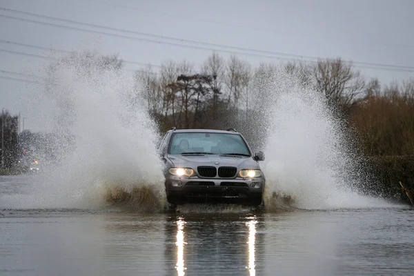 Car Makes Its Way Flooded Road Caused Storms Heavy Rain — Stock Photo, Image