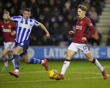 Manchester United takımından Alejandro Garnacho, Wigan Athletic 'in 8 Ocak 202' de Wigan, Wigan 'da Manchester United' a karşı oynanan üçüncü tur karşılaşmasında Wigan Atletizm Ligi 'nden Charlie Hughes' a koşuyor.