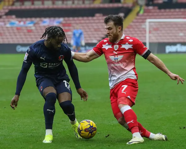 Leyton Orientt 'ten Shaqai Forde, Barnsley' den Nicky Cadden 'ı 10 Şubat 202' de Oakwell, Barnsley, Birleşik Krallık 'ta oynanan Sky Bet 1 karşılaşmasında yere serdi.