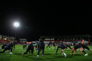 Blackpool oyuncuları, 13 Şubat 202 'de Cheltenham Town' a karşı Blackpool maçı öncesinde oynanan maç öncesi ısınma maçında Cheltenham Stadyumu, Cheltenham 'da oynanacak.