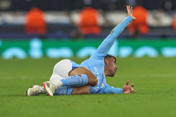 Matheus Nunes of Manchester City calls for help as he goes down injured during the UEFA Champions League match Manchester City vs F.C. Copenhagen at Etihad Stadium, Manchester, United Kingdom, 6th March 202