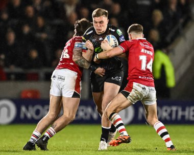 Harvie Hill of Wigan Warriors is tackled by Joe Shorrocks of Salford Red Devils and Chris Atkin of Salford Red Devils during the Betfred Super League Round 5 match Salford Red Devils vs Wigan Warriors at Salford Community Stadium, Eccles, United King clipart