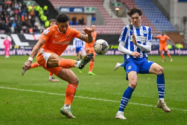 stock image Jordan Lawrence-Gabriel of Blackpool crosses the ball during the Sky Bet League 1 match Wigan Athletic vs Blackpool at DW Stadium, Wigan, United Kingdom, 16th March 2024