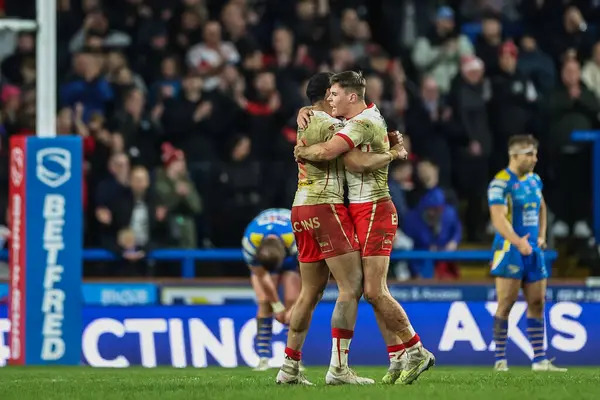 stock image Jack Welsby of St. Helens and Waqa Blake of St. Helens celebrates his sides win at the end of the Betfred Super League Round 5 match Leeds Rhinos vs St Helens at Headingley Stadium, Leeds, United Kingdom, 15th March 202