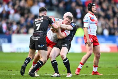 Morgan Knowles of St. Helens is tackled by Liam Marshall of Wigan Warriors and Alex Smith of Wigan Warriors during the Betfred Super League Round 6 match St Helens vs Wigan Warriors at Totally Wicked Stadium, St Helens, United Kingdom, 29th March 202 clipart