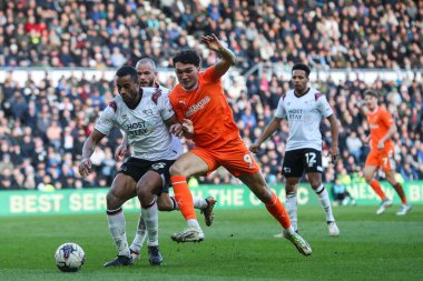 Derby County 'den Curtis Nelson ve Blackpool' dan Kyle Joseph, 21 Mart 202 'de İngiltere' nin Pride Park Stadyumu 'ndaki Derby County - Blackpool maçında top için mücadele ettiler.