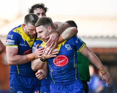 Warrington Wolves 'tan George Williams, 30 Mart 202' de İngiltere 'nin Warrington şehrinde oynanan Betfred Süper Lig karşılaşmasında Warrington Wolves ve Catalans Dragons maçında denemesini kutluyor.
