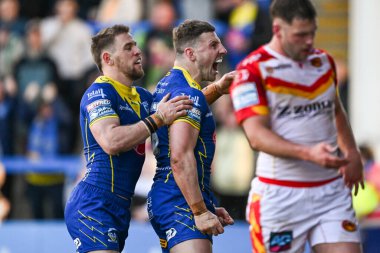 Warrington Wolves 'tan George Williams, 30 Mart 202' de İngiltere 'nin Warrington şehrinde oynanan Betfred Süper Lig karşılaşmasında Warrington Wolves ve Catalans Dragons maçında denemesini kutluyor.