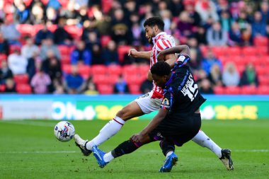 Jaheim Headley of Huddersfield Town puts a strong challenge on Josh Laurent of Stoke City during the Sky Bet Championship match Stoke City vs Huddersfield Town at Bet365 Stadium, Stoke-on-Trent, United Kingdom, 1st April 202 clipart