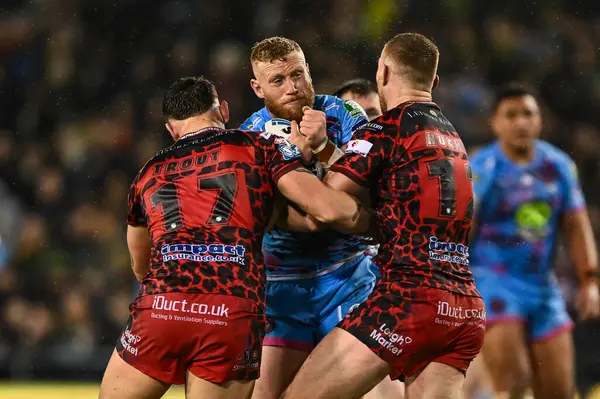 stock image Luke Thompson of Wigan Warriors is tackled by Owen Trout of Leigh Leopards and Jack Hughes of Leigh Leopards during the Betfred Super League Round 7 match Leigh Leopards vs Wigan Warriors at Leigh Sports Village, Leigh, United Kingdom, 4th April 202