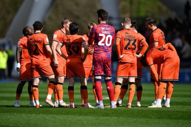Millwall players huddle together ahead of the Sky Bet Championship match Huddersfield Town vs Millwall at John Smith's Stadium, Huddersfield, United Kingdom, 6th April 2024 clipart