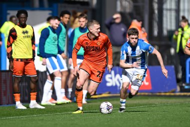 Ben Wiles of Huddersfield Town running with the ball during the Sky Bet Championship match Huddersfield Town vs Millwall at John Smith's Stadium, Huddersfield, United Kingdom, 6th April 2024 clipart