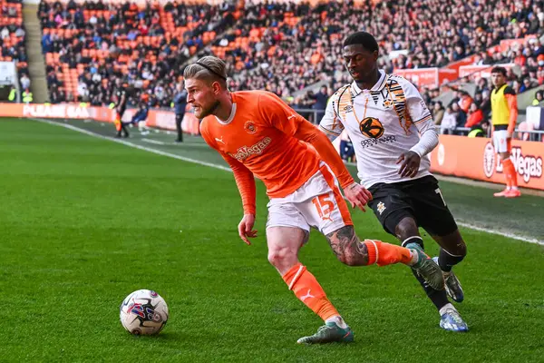 stock image Hayden Coulson of Blackpool breaks past Sullay Kaikai of Cambridge United during the Sky Bet League 1 match Blackpool vs Cambridge United at Bloomfield Road, Blackpool, United Kingdom, 6th April 202