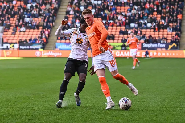 stock image Sonny Carey of Blackpool and Jordan Cousins of Cambridge United battle for the ball during the Sky Bet League 1 match Blackpool vs Cambridge United at Bloomfield Road, Blackpool, United Kingdom, 6th April 202