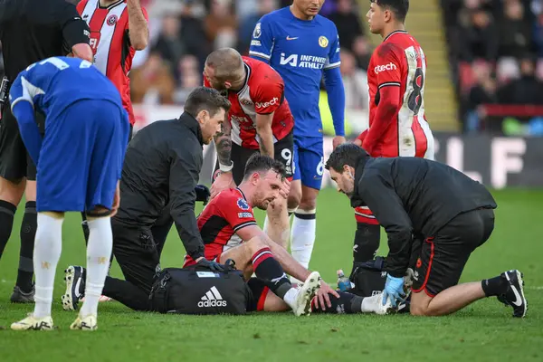 stock image Jack Robinson of Sheffield United receives treatment during the Premier League match Sheffield United vs Chelsea at Bramall Lane, Sheffield, United Kingdom, 7th April 202