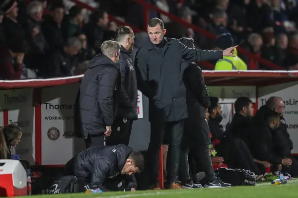 stock image Neill Collins Head coach of Barnsley speaks to Martin Devaney first team coach of Barnsley and Jon Stead first team coach of Barnsley during the Sky Bet League 1 match Stevenage vs Barnsley at Lamex Stadium, Stevenage, United Kingdom, 9th April 202