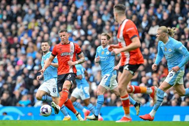 Ross Barkley of Luton Town passes the ball, during the Premier League match Manchester City vs Luton Town at Etihad Stadium, Manchester, United Kingdom, 13th April 202 clipart