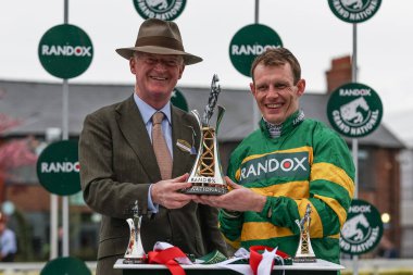 Willie Mullins (L) and Paul Townend (R) with the winners trophy after I Am Maximus wins the 16:00 Randox Grand National Handicap Chase during the Randox Grand National Day 2024 at Aintree Racecourse, Liverpool, United Kingdom, 13th April 202 clipart