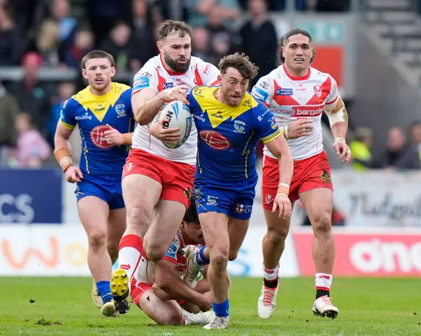 stock image Matty Ashton of Warrington Wolves makes a break past Alex Walmsley of St. Helens during the Betfred Challenge Cup Quarter Final match St Helens vs Warrington Wolves at Totally Wicked Stadium, St Helens, United Kingdom, 14th April 202