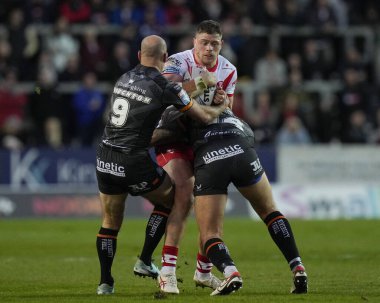 Morgan Knowles of St. Helens runs at Danny Houghton of Hull FC during the Betfred Super League  Round 8 match St Helens vs Hull FC at Totally Wicked Stadium, St Helens, United Kingdom, 19th April 202 clipart
