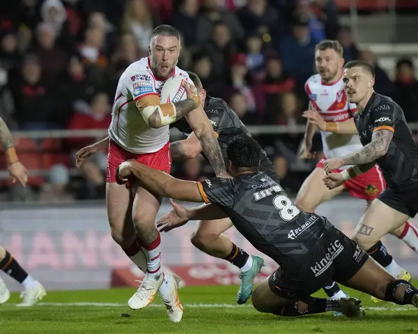 stock image Curtis Sironen of St. Helens drives past Herman Eseese of Hull FC to score during the Betfred Super League  Round 8 match St Helens vs Hull FC at Totally Wicked Stadium, St Helens, United Kingdom, 19th April 2024