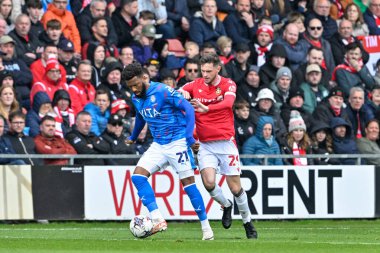 Myles Hippolyte of Stockport County and Ryan Barnett of Wrexham battle for the ball, during the Sky Bet League 2 match Wrexham vs Stockport County at SToK Cae Ras, Wrexham, United Kingdom, 27th April 202 clipart