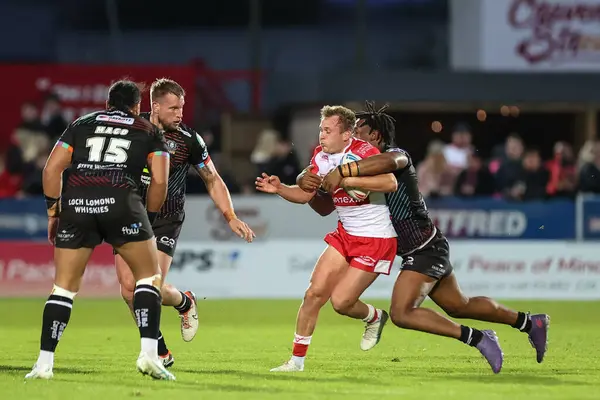 stock image Jez Litten of Hull KR is tackled by Junior Nsemba of Wigan Warriors during the Betfred Super League Round 9 match Hull KR vs Wigan Warriors at Sewell Group Craven Park, Kingston upon Hull, United Kingdom, 26th April 202