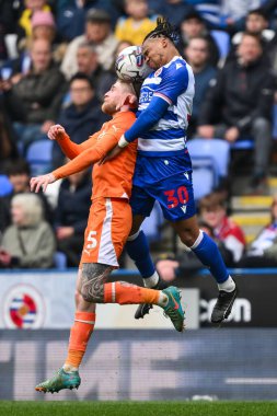 Hayden Coulson of Blackpool and Kelvin Abrefa of Reading battle to win the high ball during the Sky Bet League 1 match Reading vs Blackpool at Select Car Leasing Stadium, Reading, United Kingdom, 27th April 202 clipart