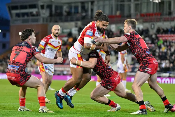 stock image Chris Satae of Catalan Dragons gets tackled, during the Betfred Super League Round 9 match Leigh Leopards vs Catalans Dragons at Leigh Sports Village, Leigh, United Kingdom, 26th April 202