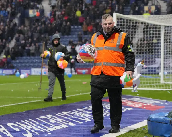 stock image Stewards were busy clearing inflatables fthrown on to the  pitch before the Sky Bet Championship match Preston North End vs Leicester City at Deepdale, Preston, United Kingdom, 29th April 202