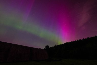 Northern Lights over Derwent Dam where Barnes Wallis Dam Busters practiced during WW2, Bamford, The Peak District National Park, United Kingdom, 10th May 2024  clipart