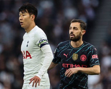 Son Heung-Min of Tottenham Hotspur and Bernardo Silva of Manchester City look on during the Premier League match Tottenham Hotspur vs Manchester City at Tottenham Hotspur Stadium, London, United Kingdom, 14th May 2024  clipart