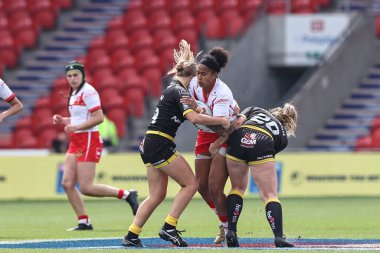 Chantelle Crowl tackled by Alex Stimpson and Lacy Owen during the Betfred Women's Challenge Cup match St Helens Women vs York City Knights Women at Eco-Power Stadium, Doncaster, United Kingdom, 18th May 2024