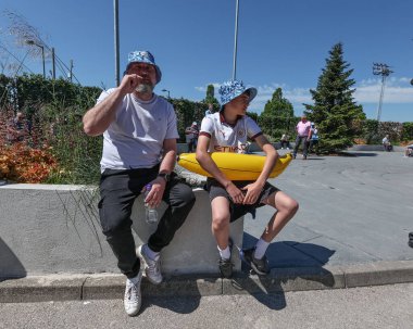 Man City fans arrive at the Etihad Stadium with the sun shining and clear blue skies during the Premier League match Manchester City vs West Ham United at Etihad Stadium, Manchester, United Kingdom, 19th May 2024 