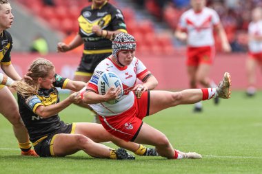 Katie Mottershead of St Helens is tackled by Alex Stimpson of York RLFC Valkyrie during the Betfred Women's Challenge Cup match St Helens Women vs York City Knights Women at Eco-Power Stadium, Doncaster, United Kingdom, 18th May 2024
