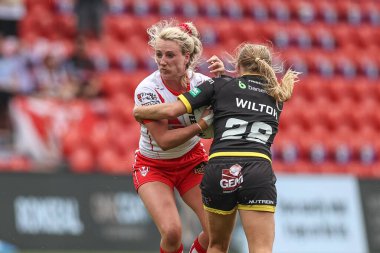 Jodie Cunningham of St Helens is tackled by Remi Wilton of York RLFC Valkyrie during the Betfred Women's Challenge Cup match St Helens Women vs York City Knights Women at Eco-Power Stadium, Doncaster, United Kingdom, 18th May 2024 clipart