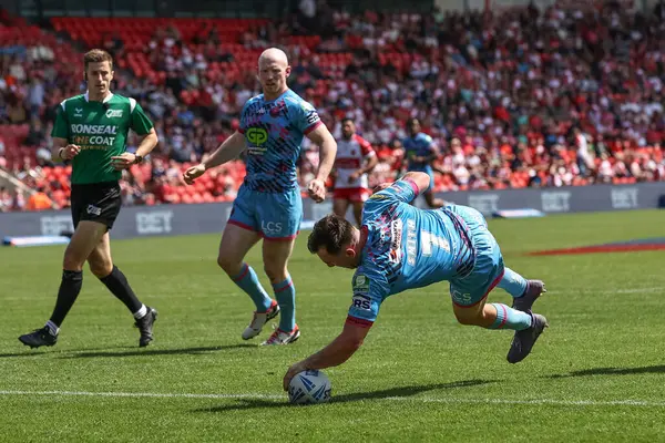 stock image Harry Smith of Wigan Warriors goes over for a try during the Betfred Challenge Cup Semi-Final Hull KR v Wigan Warriors at Eco-Power Stadium, Doncaster, United Kingdom, 18th May 2024