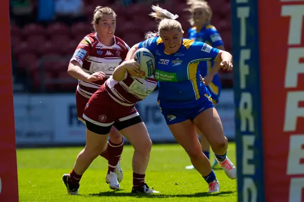 Stock image Zoe Hornby of Leeds Rhinos drives for the try line during the Betfred Women's Challenge Cup Semi-Final match Leeds Rhinos vs Wigan Warriors at Totally Wicked Stadium, St Helens, United Kingdom, 19th May 2024