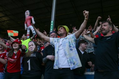 Nottingham Forest fans celebrate their teams win securing Premier League football for next season after the Premier League match Burnley vs Nottingham Forest at Turf Moor, Burnley, United Kingdom, 19th May 2024