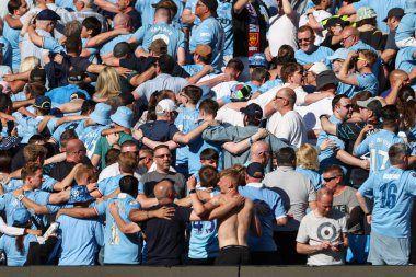 Man City supporters cheer on their team during the Premier League match Manchester City vs West Ham United at Etihad Stadium, Manchester, United Kingdom, 19th May 2024 