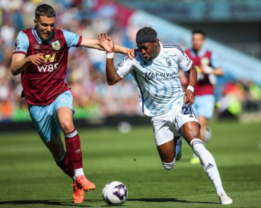 Anthony Elanga of Nottingham Forest holds off Maxime Esteve of Burnley during the Premier League match Burnley vs Nottingham Forest at Turf Moor, Burnley, United Kingdom, 19th May 2024